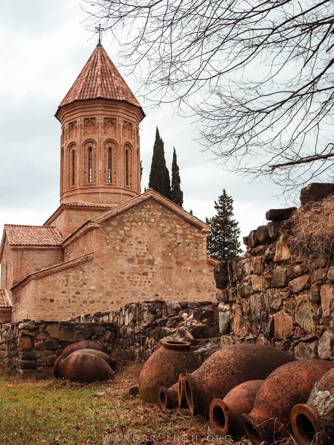 Ikalto Monastery, a stone church surrounded by clay Qvevri.