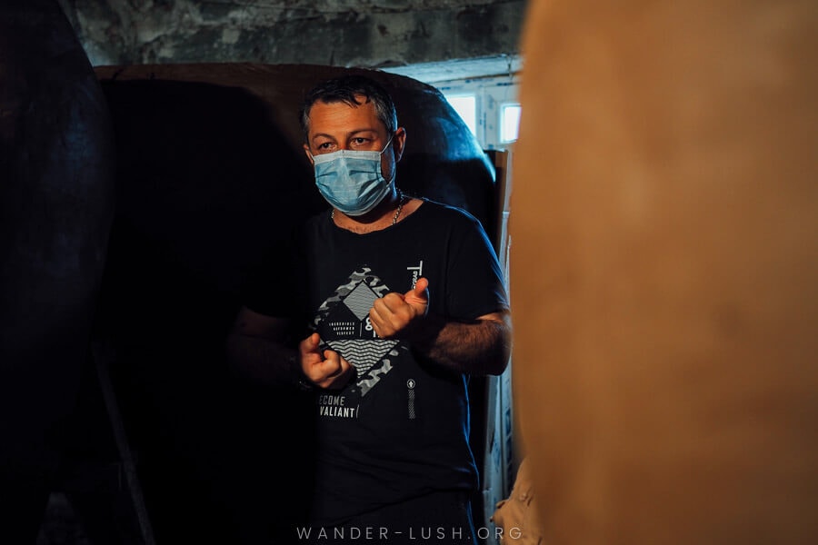 A man explains how he makes clay Georgian qvevri at his workshop in Telavi, Kakheti.
