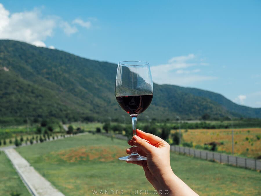A woman raises a glass of red wine at a winery in Kaketi, Georgia.
