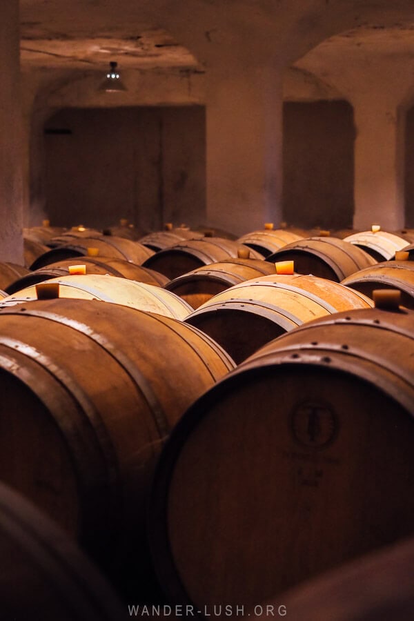 Oak barrels inside an underground spirit tunnel in Kakheti, Georgia.