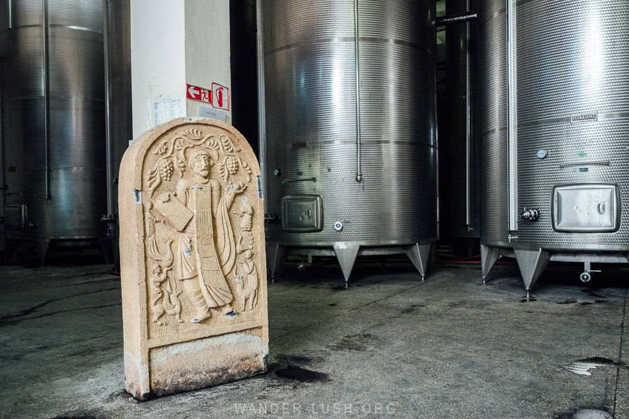 Steel vats and a Soviet-style frieze sculpture inside a winery in Georgia.