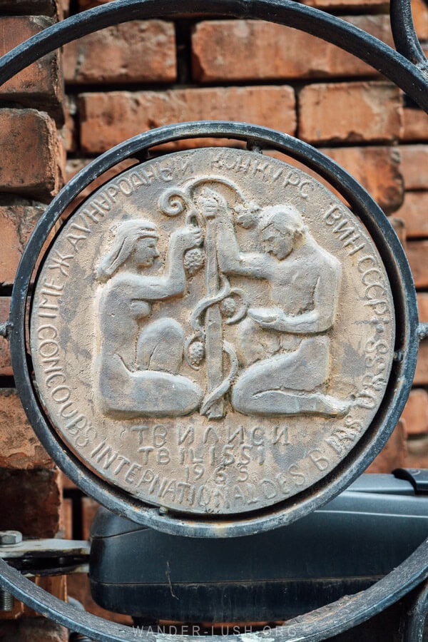 A Soviet-era medallion decorates the gate to a wine factory in Gurjaani, Georgia.
