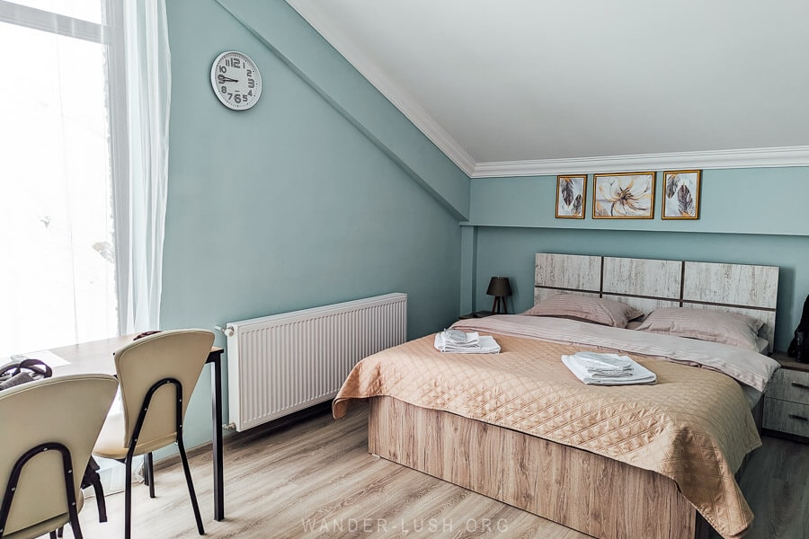 A guesthouse room with green walls and heating at a hotel in Gudauri, Georgia.