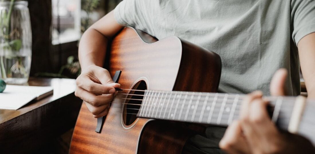 playing an acoustic guitar