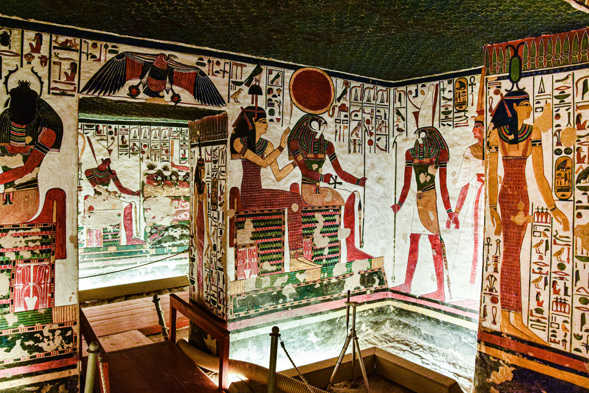 The inside of the richly decorated tomb of Nefertari at the Valley of the Queens in Luxor portrays gods and funerary scenes in bright colors on a background of white. 