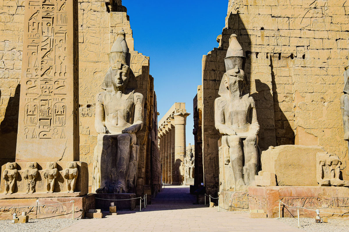 Enormous statues and columns line the entrance to the Luxor Temple in Luxor, Egypt. 