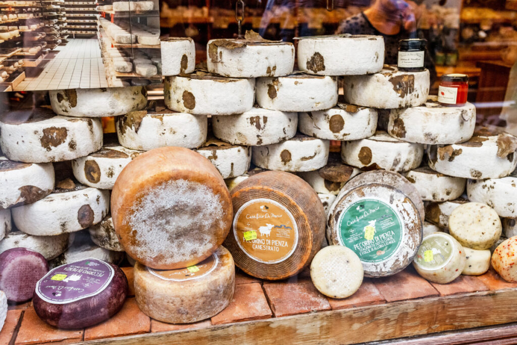 Market sale of Pecorino cheese in Pienza , Italy