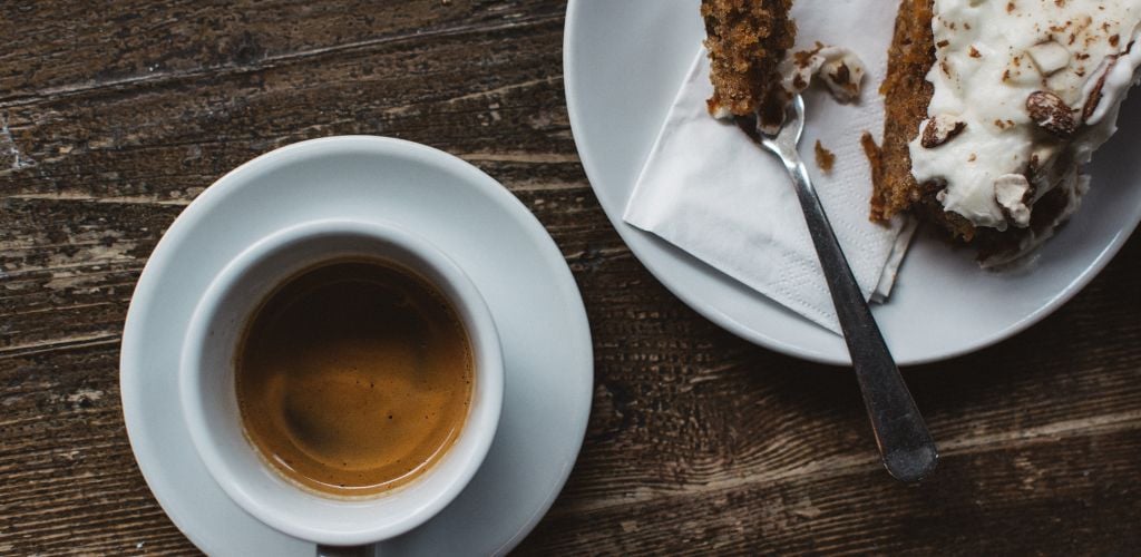 cake and coffee on a dark wooden table