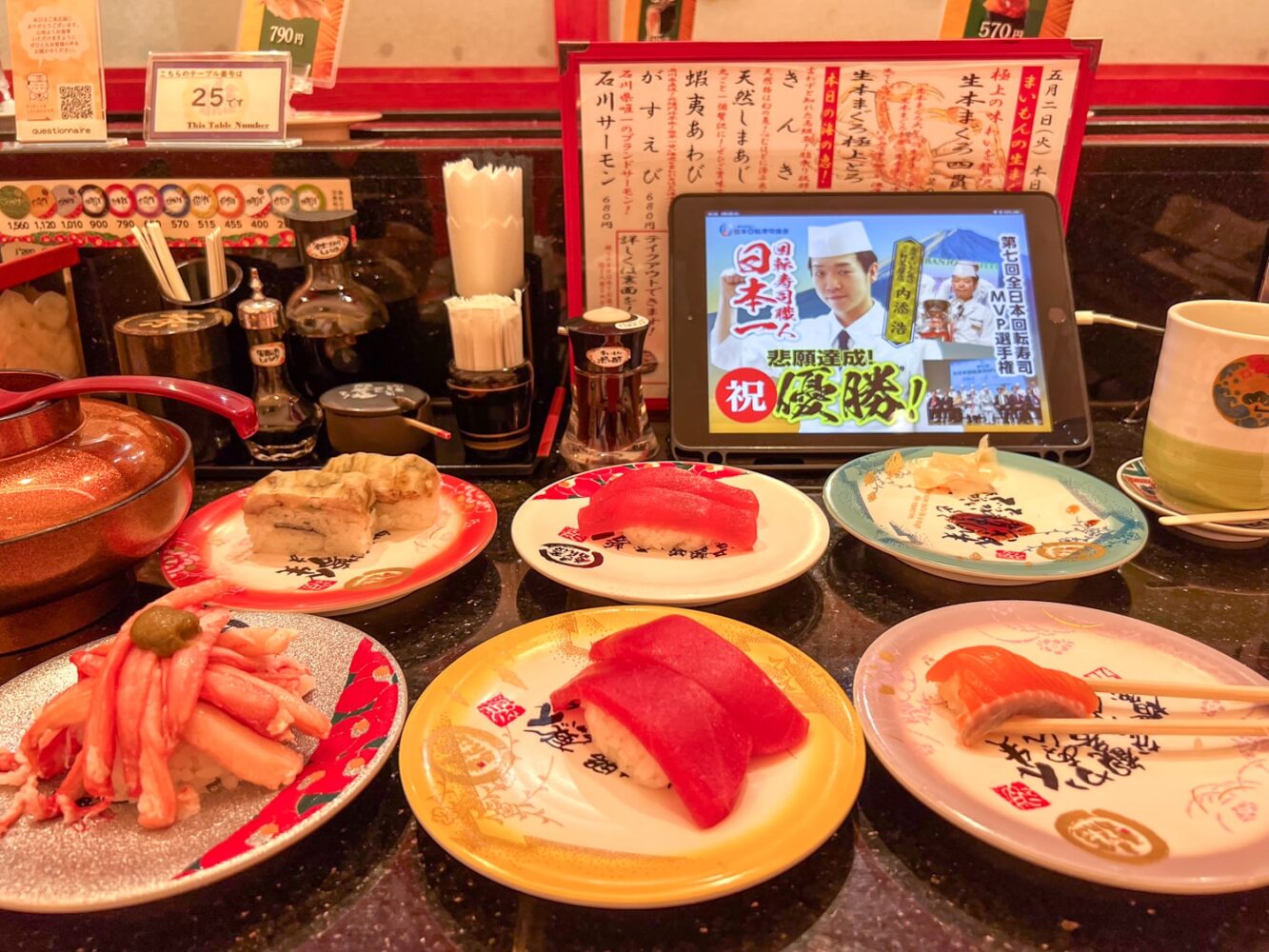 Mini plates with conveyor belt sushi inside a typical sushi restaurant in Tokyo.