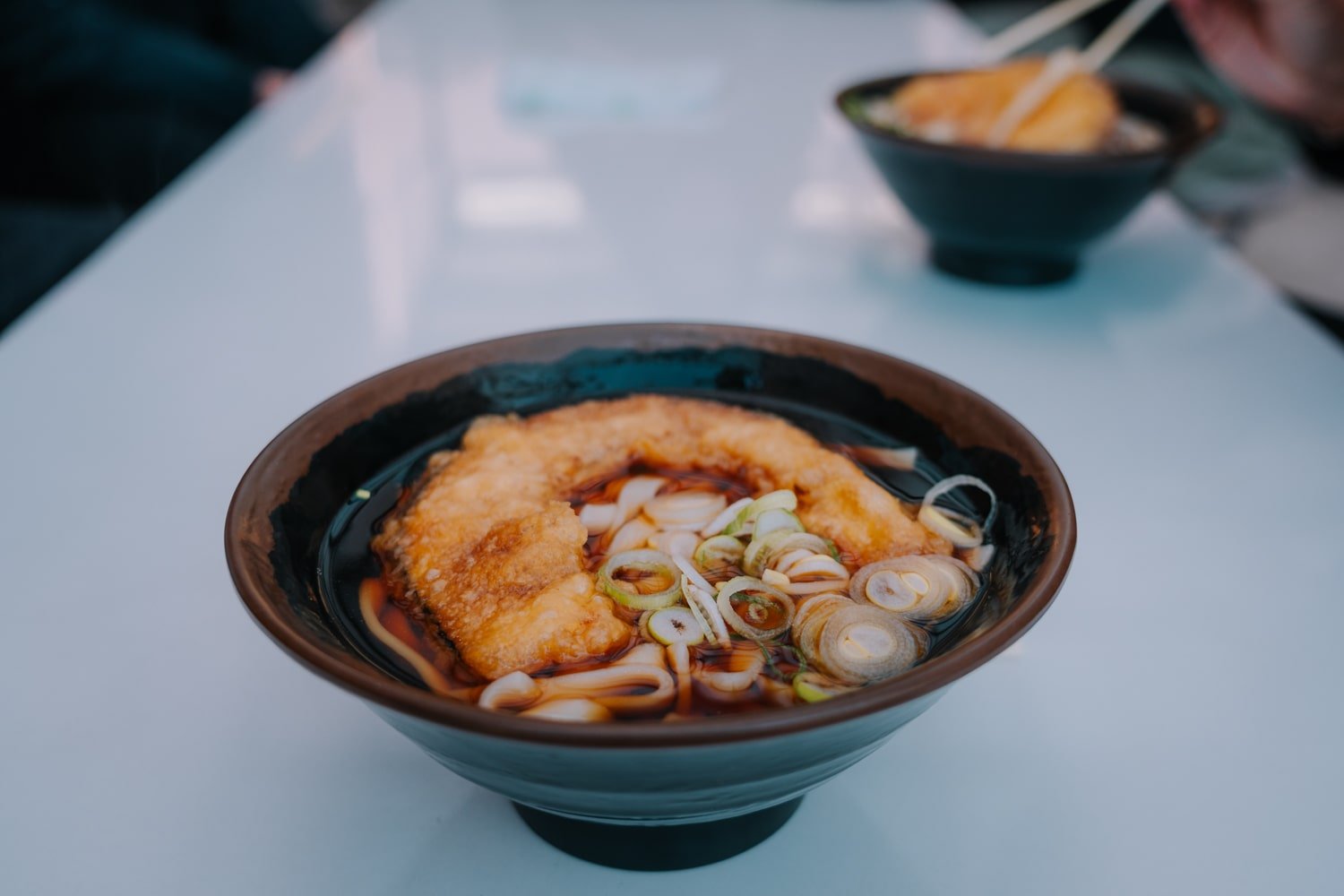 A bowl of Kishimen Noodles with deep-fried pumpkin, a local salaryman lunch spot in Tokyo, Japan.