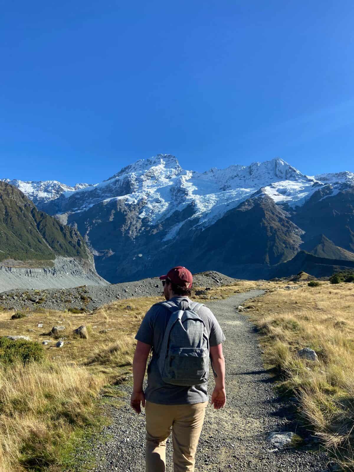 Colin wearing a backpack while we walk the Hooker Valley Track at Aoraki Mt Cook, New Zealand