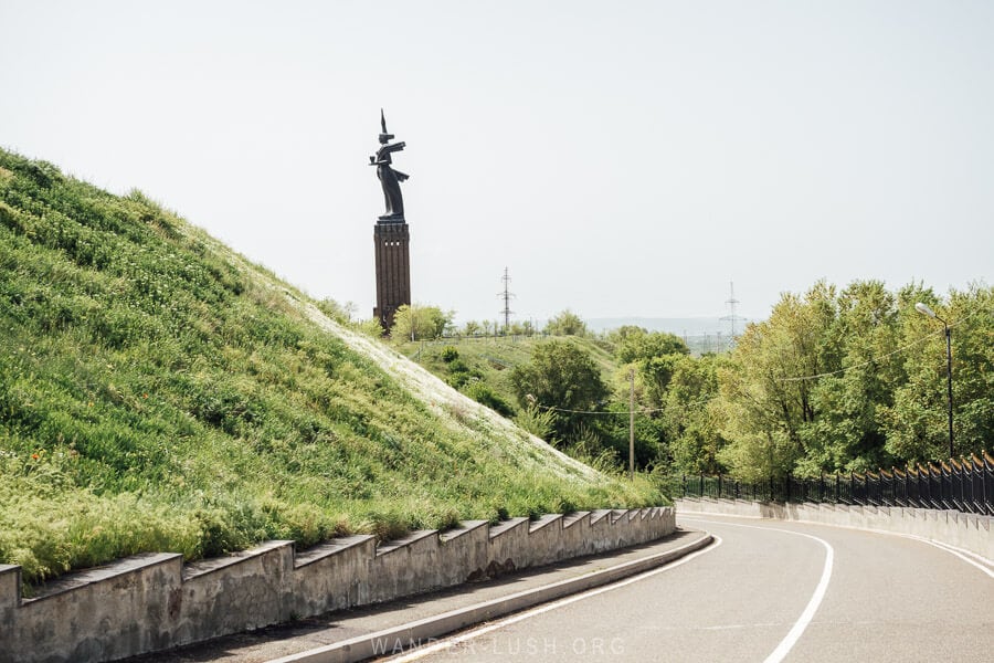 A stretch of highway runs past a Soviet-era statue in Gyumri, Armenia.