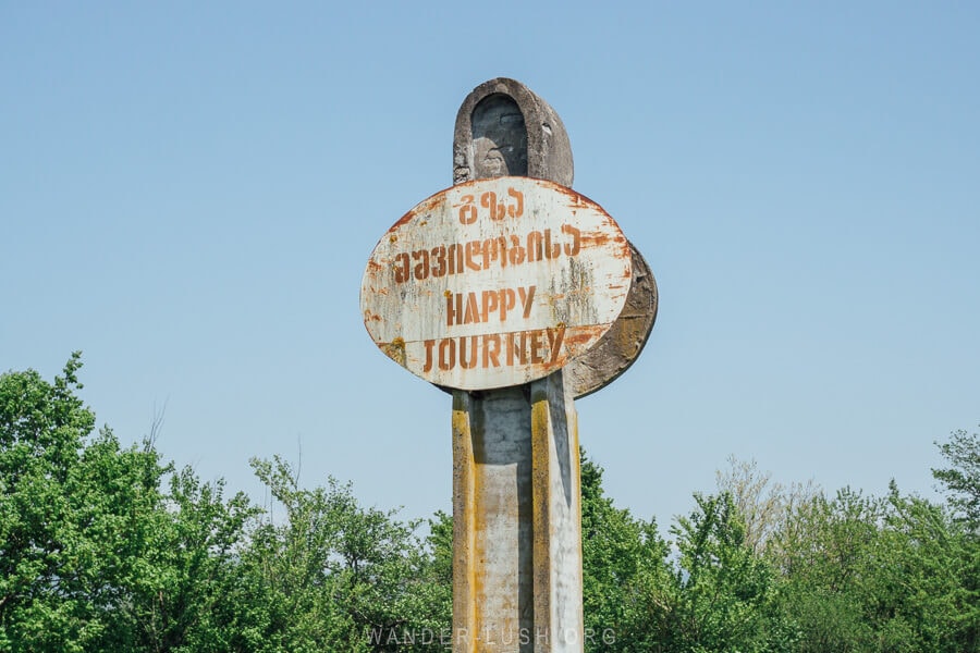 A road sign in Georgia reads happy journey.