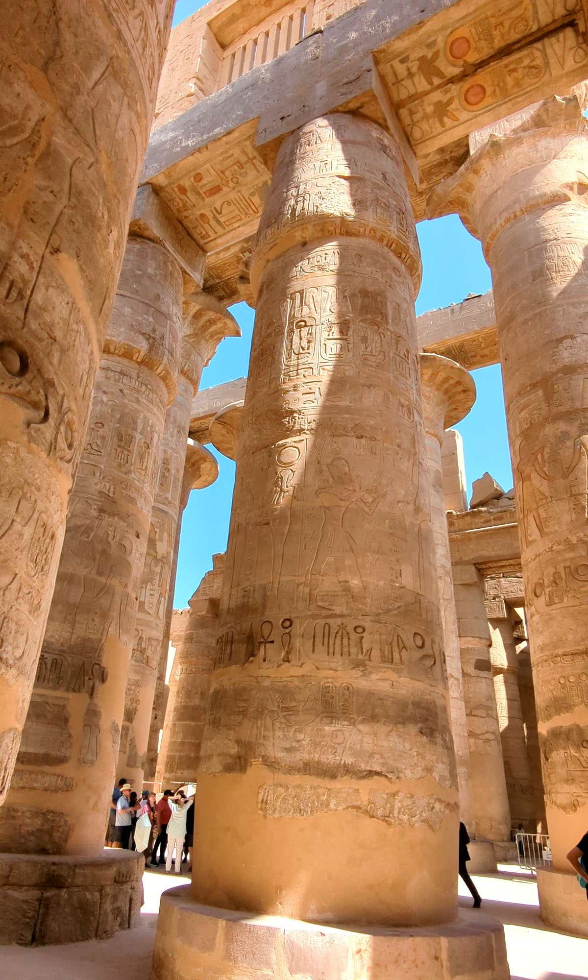 Enormous columns filled with hieroglyphs line the hypostyle hall inside Karnak Temple in Luxor. 