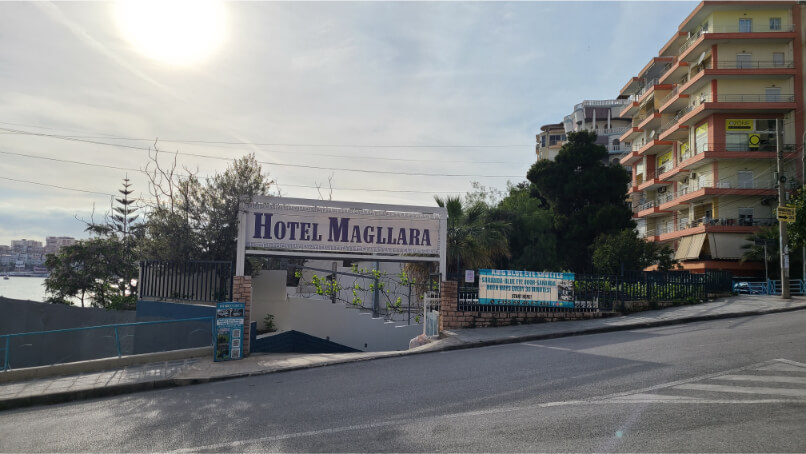 Sign for shuttles to Blue Eye on the fence outside of Saranda Hotel Magllara.