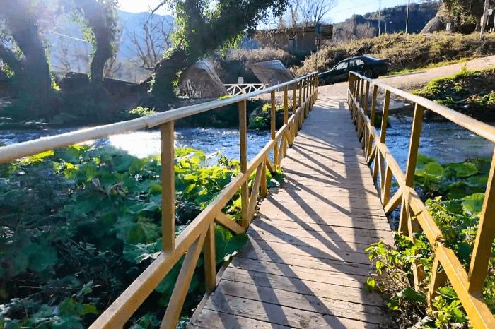 One of the two yellow bridges that cross the river at Blue Eye. The blue river is visible below.