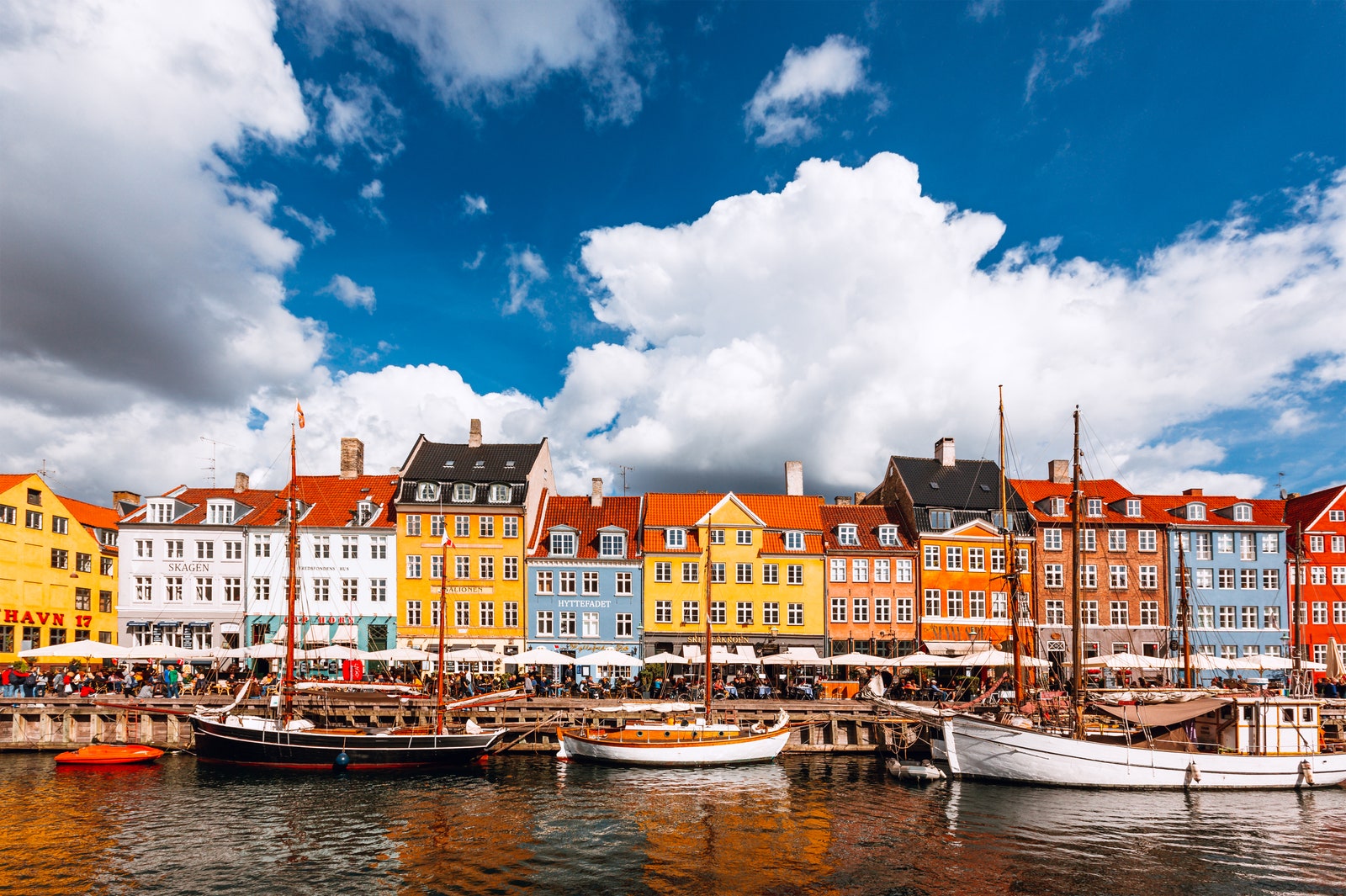 Multicolored vibrant houses along Nyhavn harbor on a sunny day Copenhagen Denmark