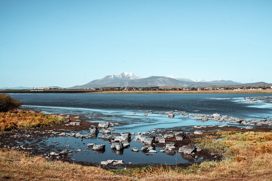 A beautiful alpine blue lake with a volcano in the background on Georgia's Javakheti Plateau.