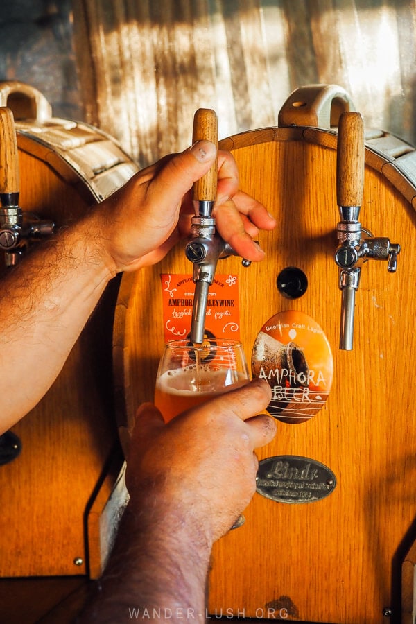 A man pours beer into a glass at a craft brewery in Akhaltsikhe, Georgia.