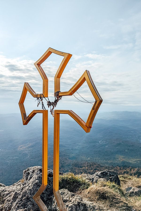 A gold cross on the peak of Tskhrajvari in Georgia.