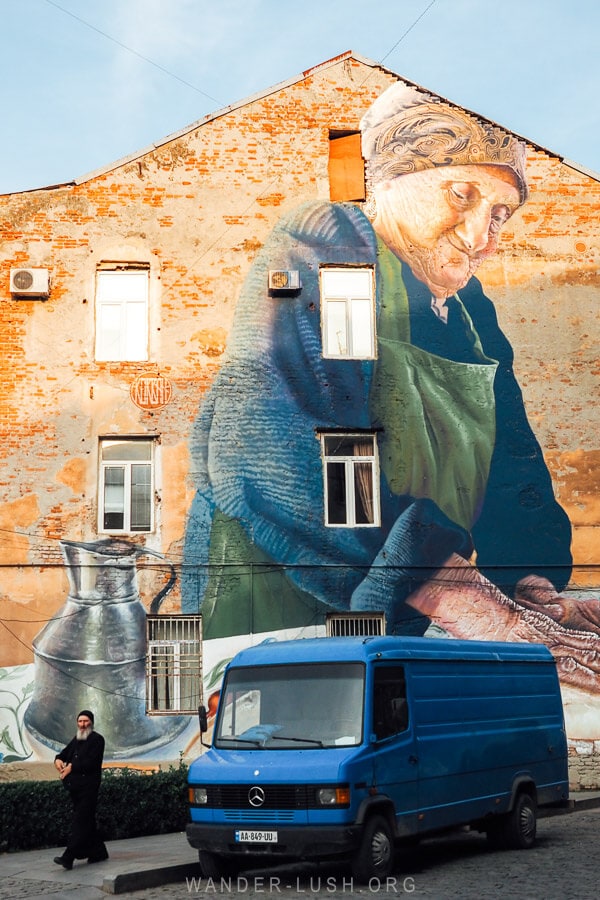 Street art in Kutaisi showing an old woman making khachapuri.