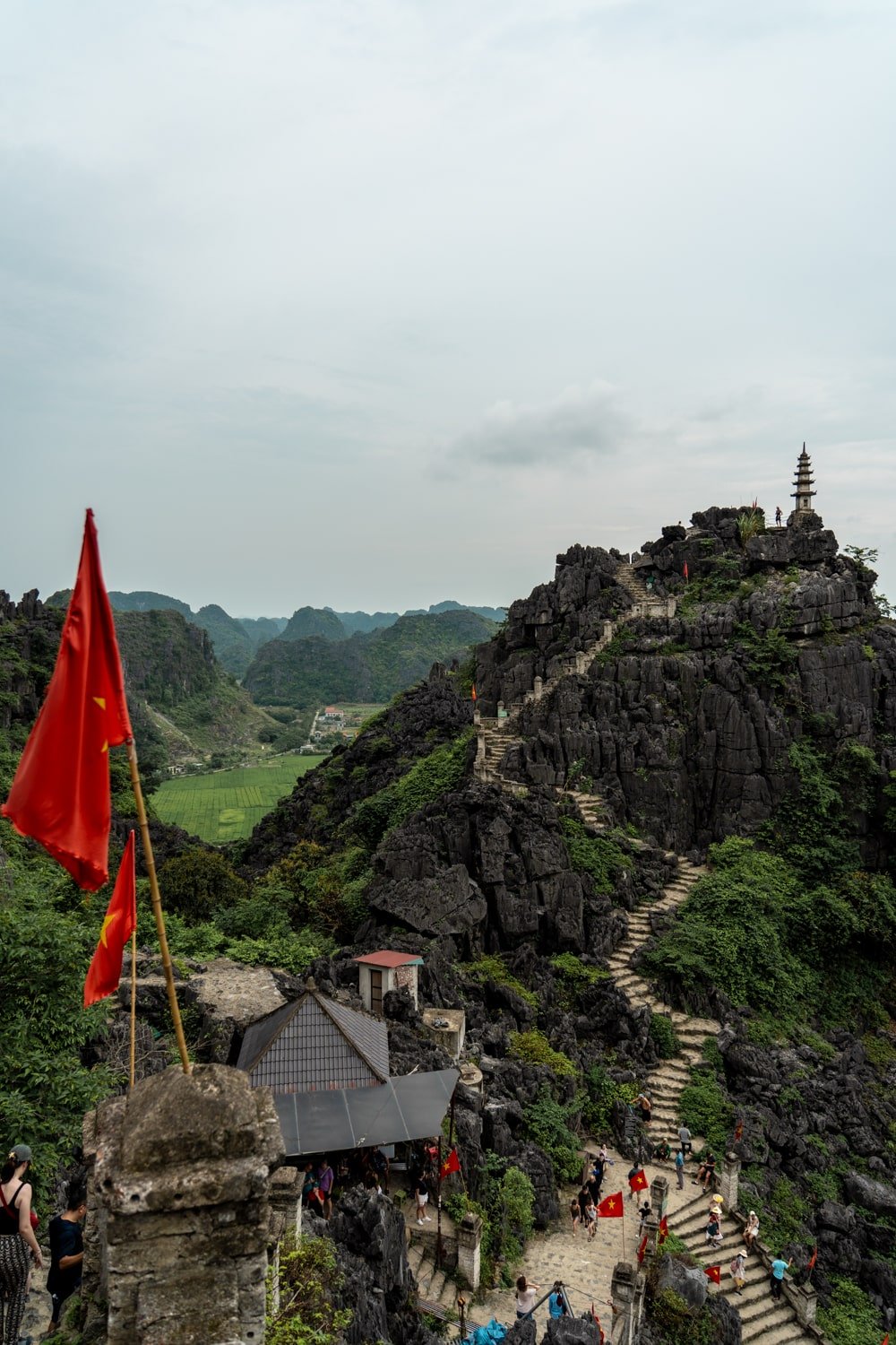 Observation deck at Mua Caves overlooking stone staircase and Hang Mua Pagoda in Northern Vietnam.