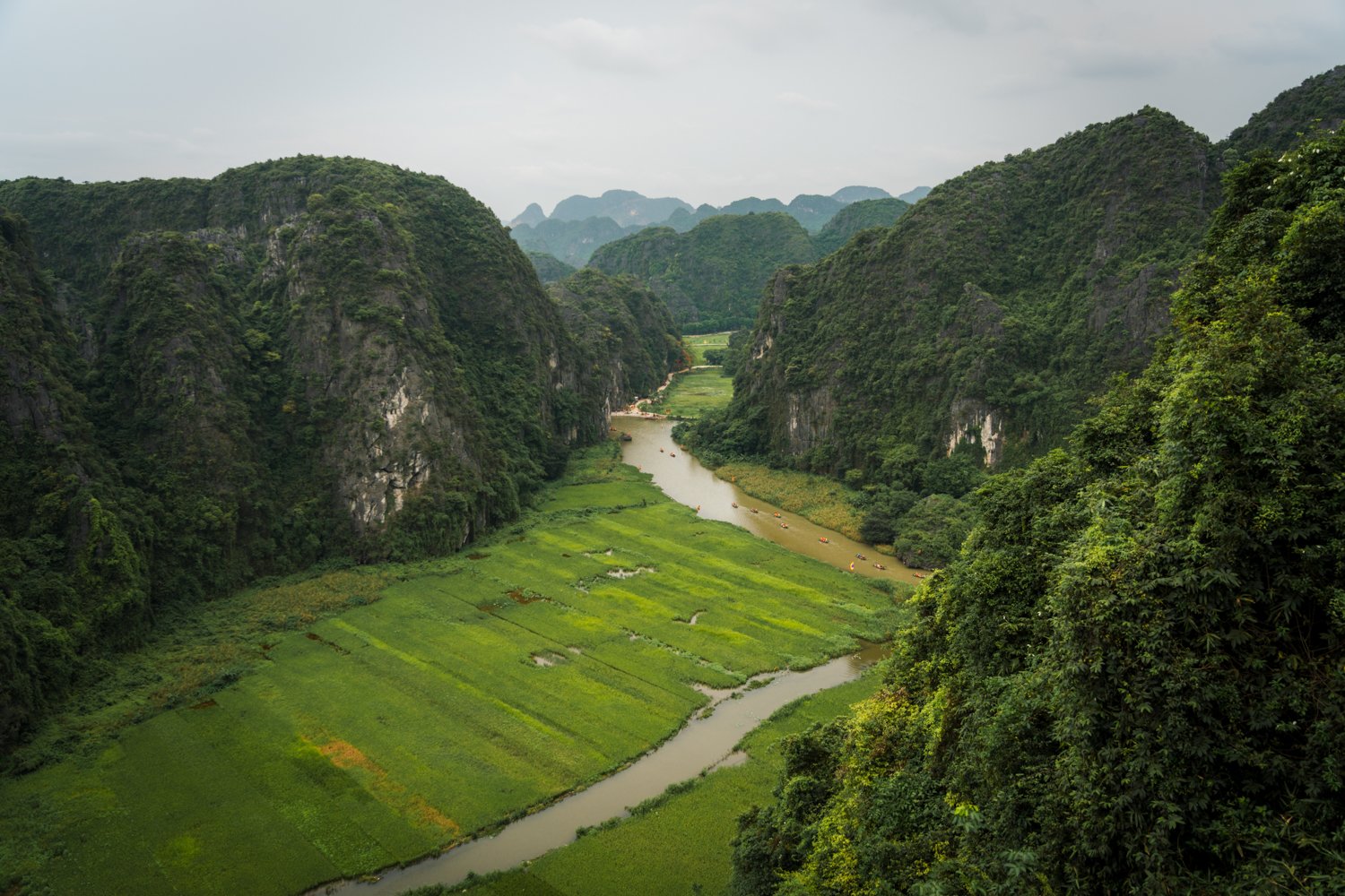 View of UNESCO-protected Tam Coc with limestone karsts and Ngao Long River inside the Trang An Scenic Complex Landscape near Ninh Binh, Vietnam.