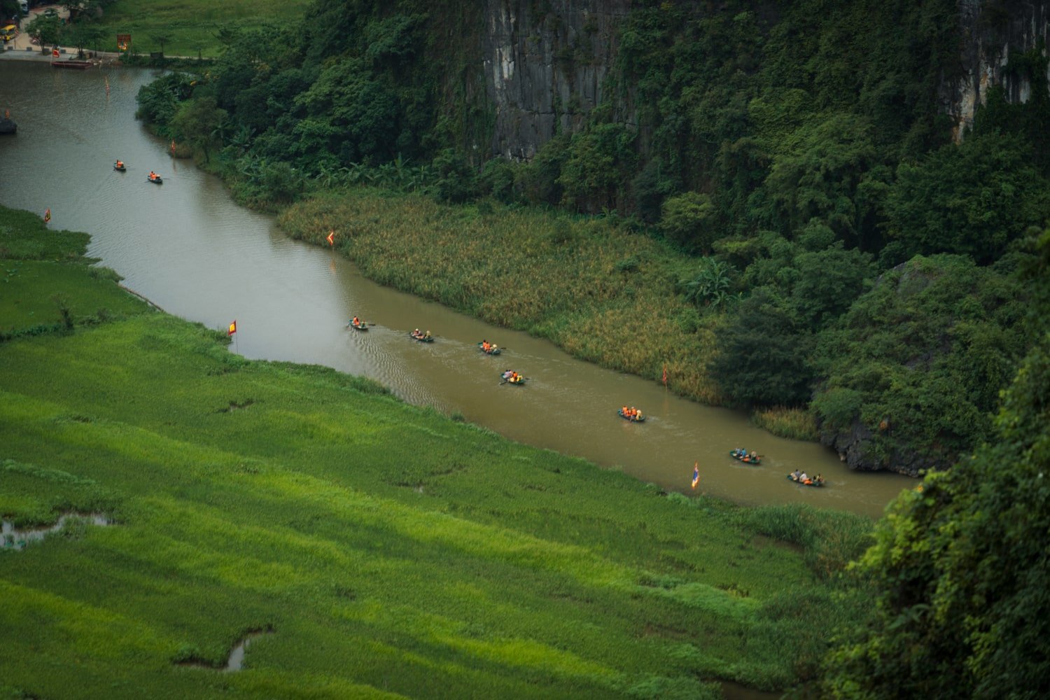 Tour boats on the Ngao Long river at Tam Coc, Vietnam.