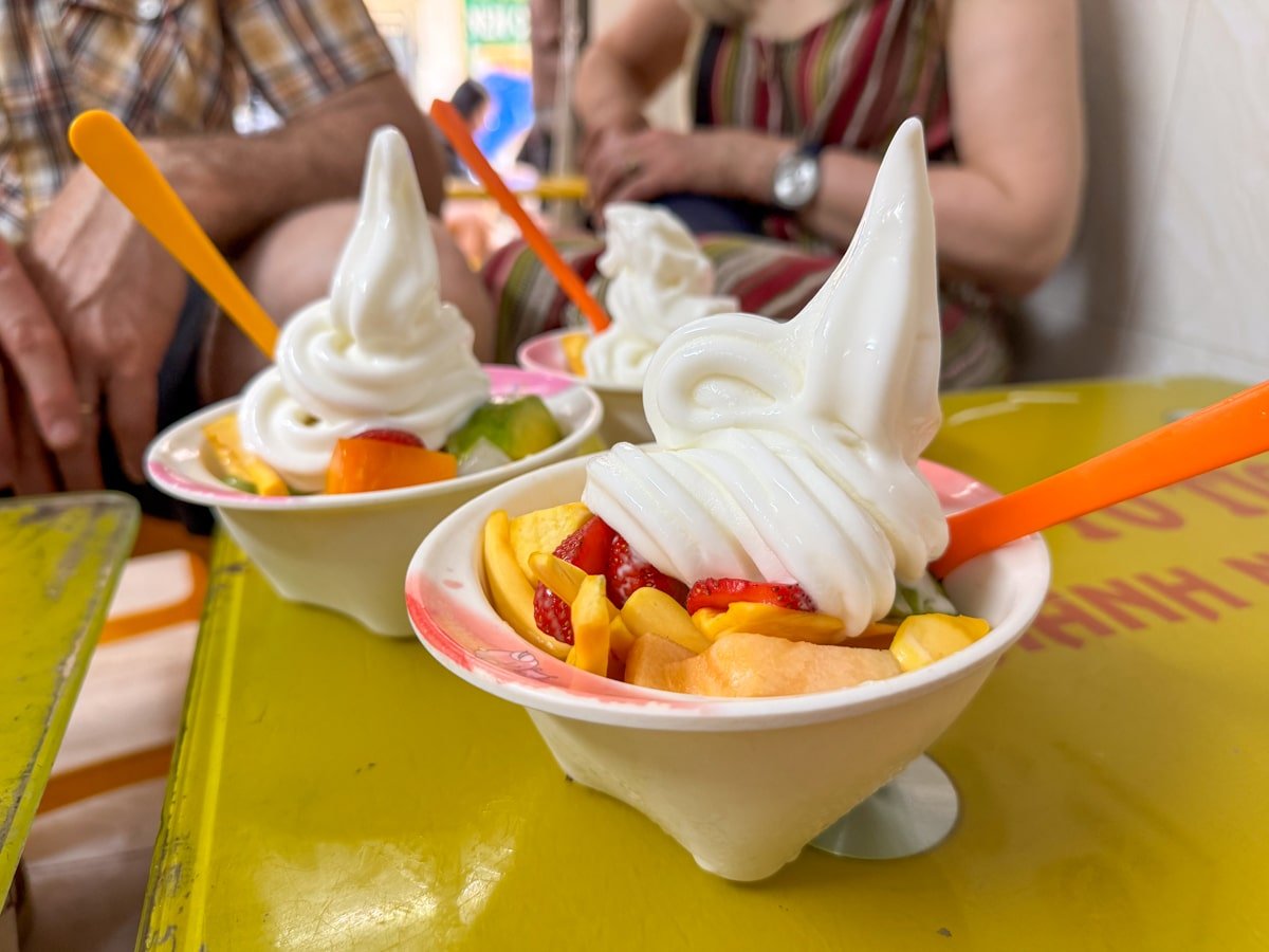 Coconut ice cream with mixed fruits at a local stall in Hanoi, Vietnam.