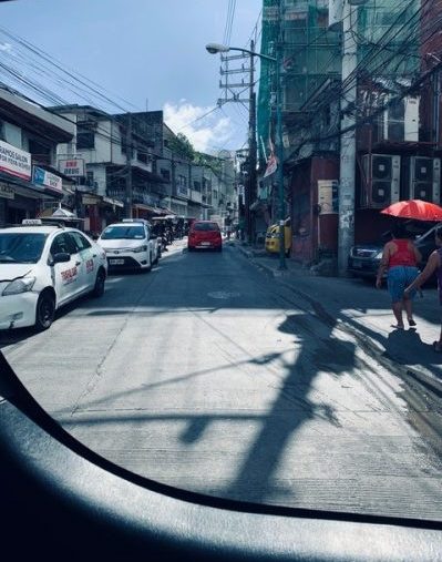 A view of traffic from a car window from the Philippines.