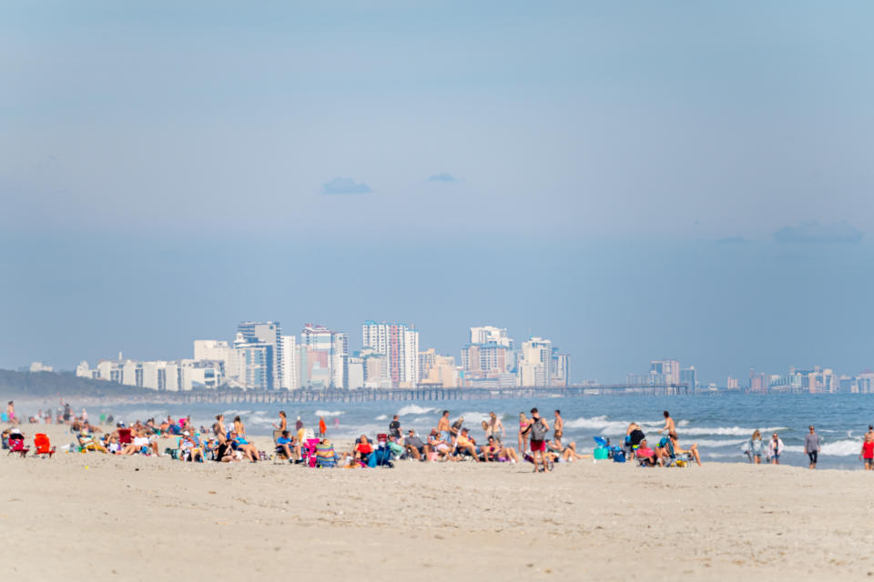 Myrtle Beach South Carolina Skyline with crowds gathered on a nearby beach.