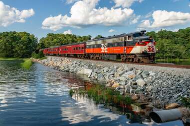 a Cape Cod Railroad train going over a lake 