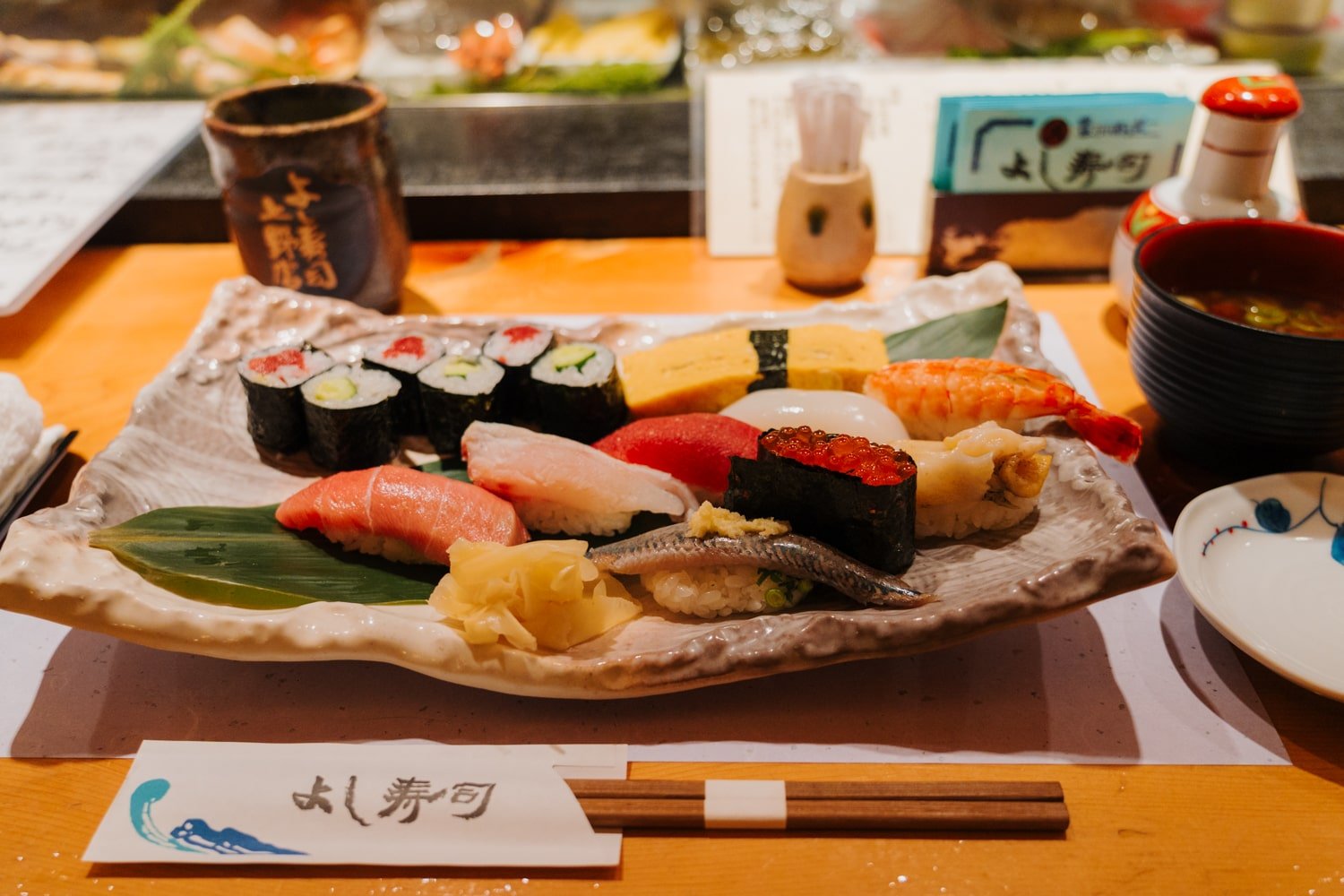 Plate of high-quality Japanese sushi with various nigiri sushi and maki sushi.