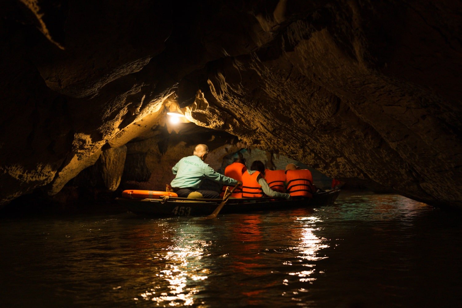 A Trang An boat tour inside one of the many caves and grottoes of the Trang An Scenic Complex Landscape in Northern Vietnam.