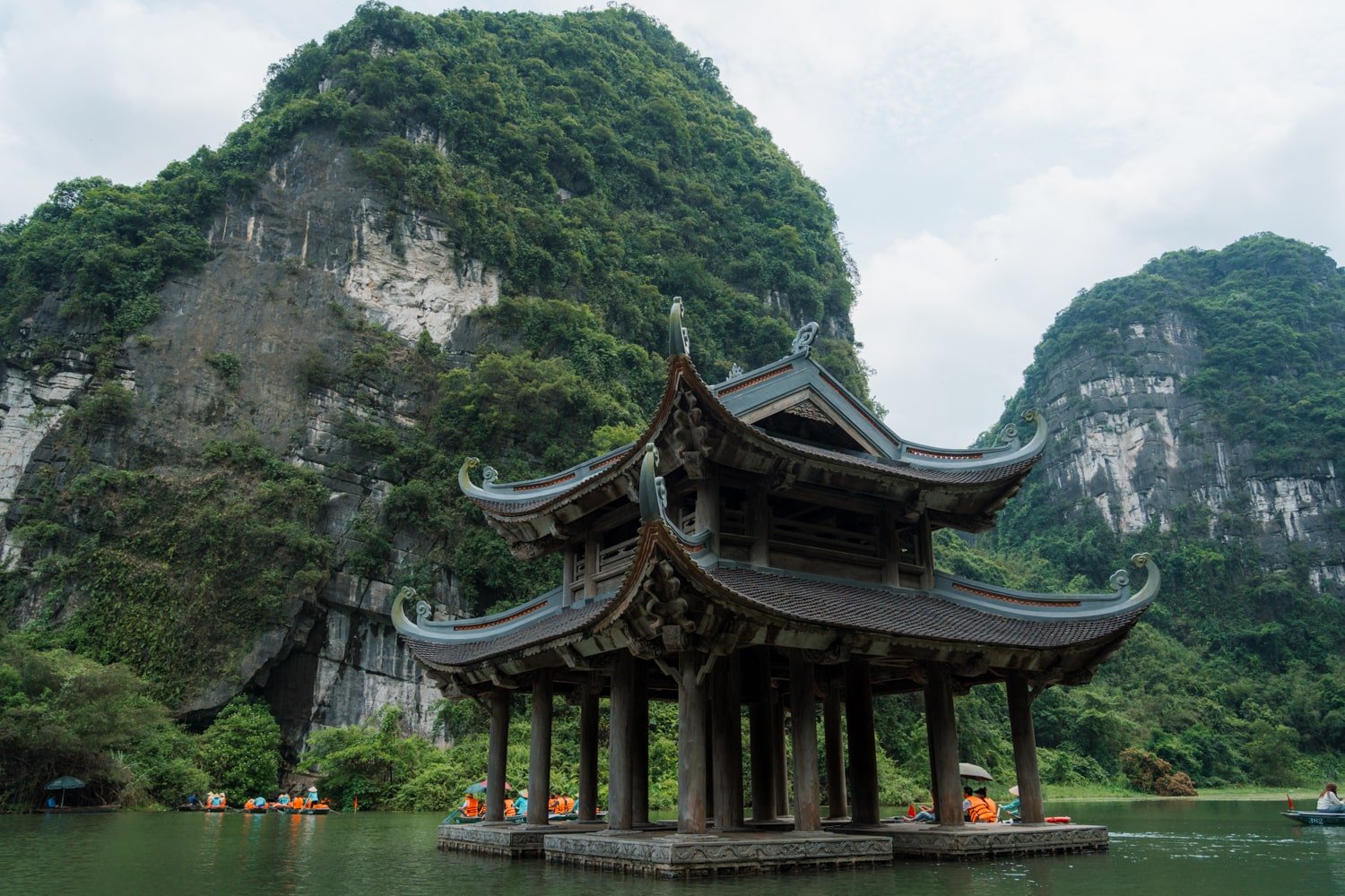 Suoi Tien Temple surrounded by water and the Dia Linh Mountain in Trang An, Vietnam.