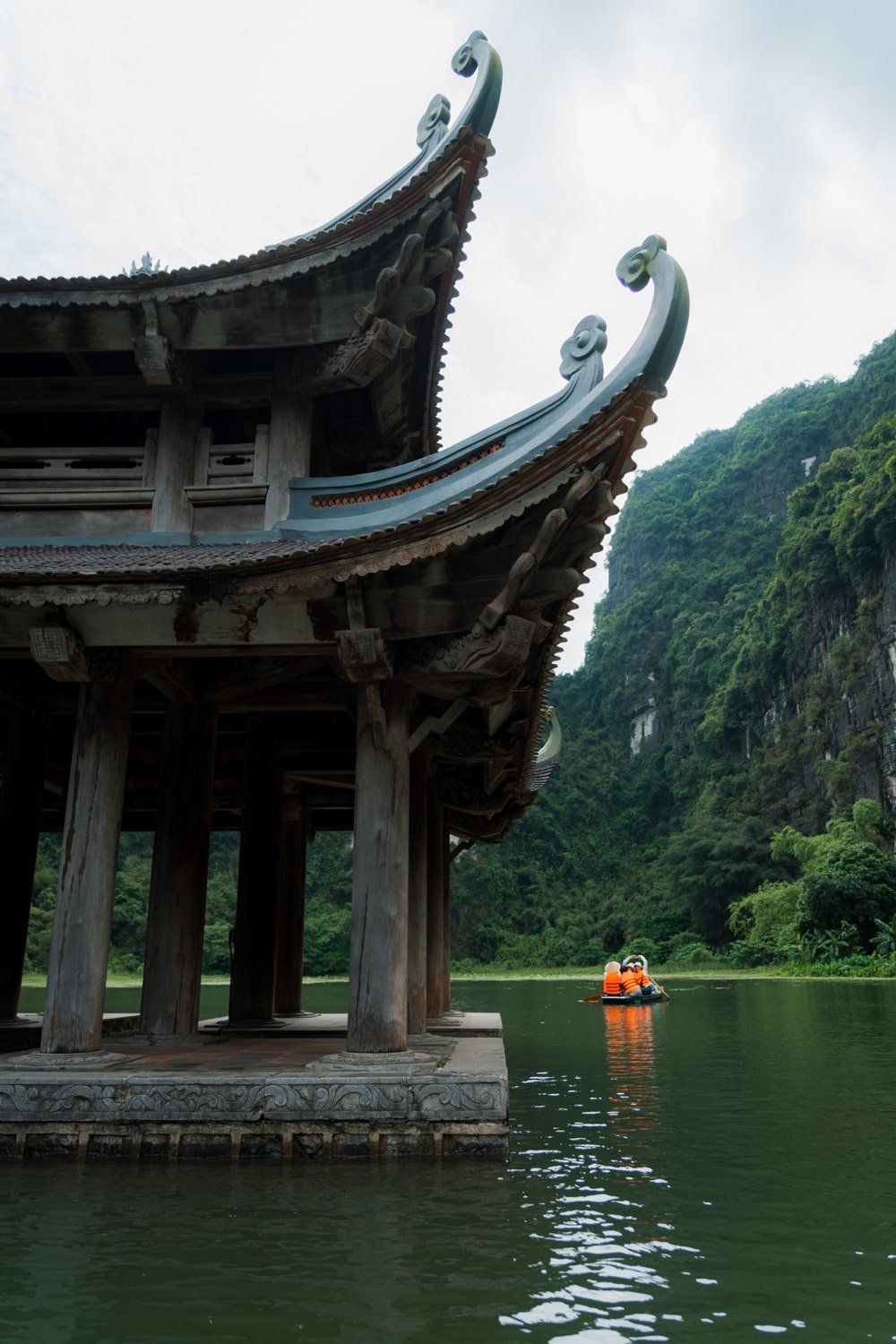 Suoi Tien Temple surrounded by water and the Dia Linh Mountain in Trang An, Vietnam.