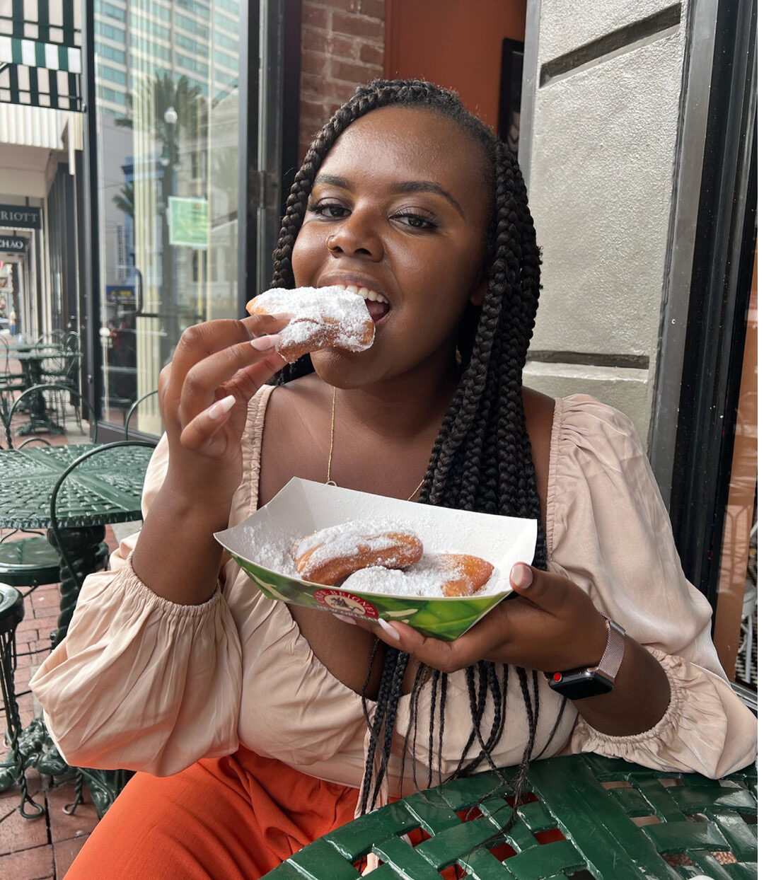 Christina Jane eating beignets in New Orleans, USA