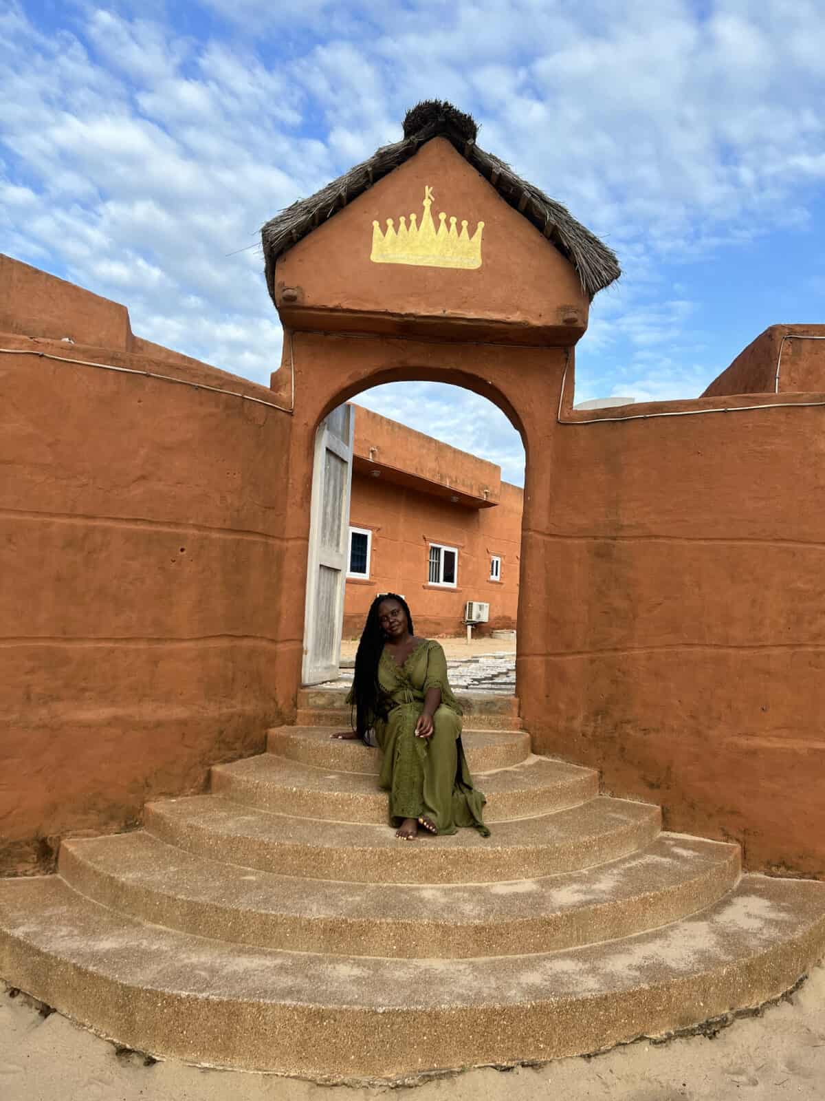 Christina Jane sitting on steps outside in Togo