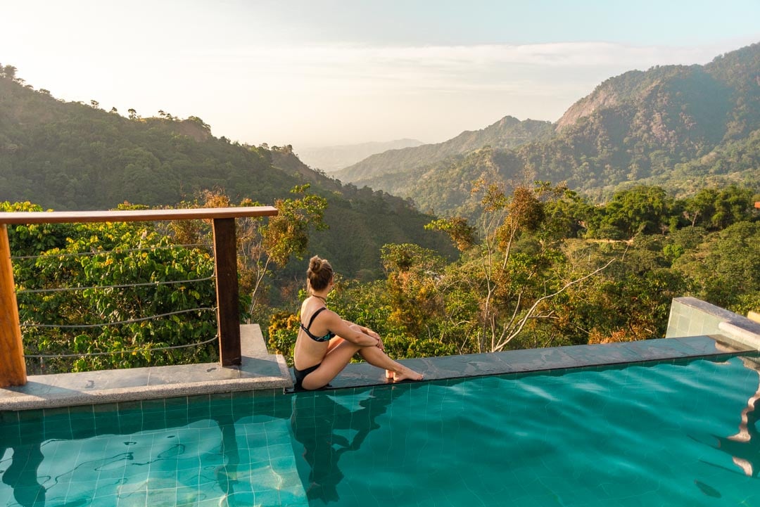 Bailey sits on the edge of the pool at Casas Viejas and overlooks Minca, Colombia