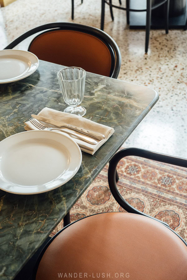 A stone table and a Caucasian carpet decorate a beautiful restaurant in Tbilisi, Georgia.