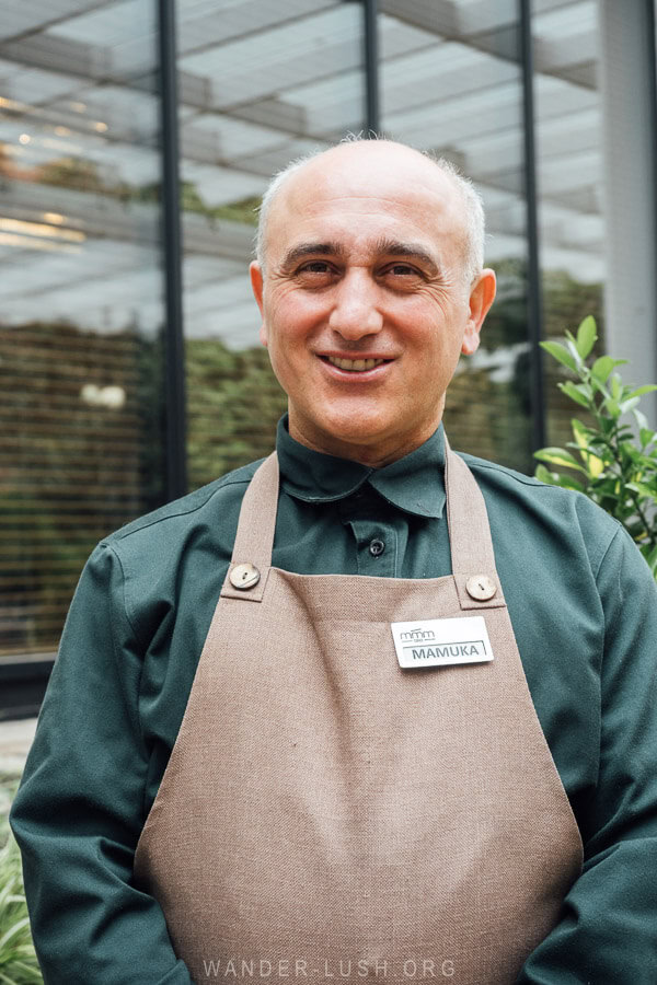 A smiling waiter at a restaurant.