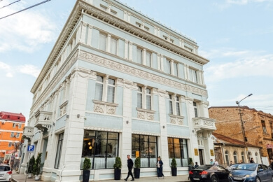 Baby blue facade of the Hotel Newport, a boutique hotel in Kutaisi located inside the old courthouse.