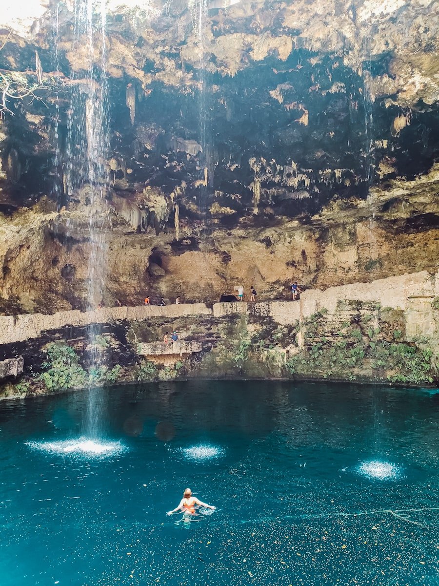 woman swimming in cenote zaci in valladolid