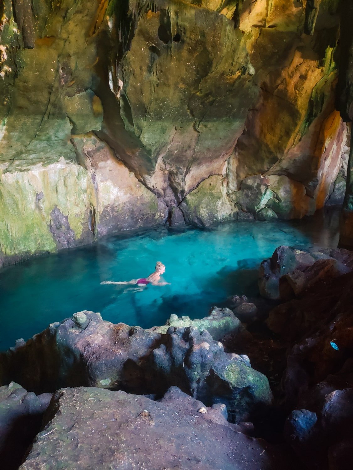 Bucketlist Bri swimming in a semi-open cave cenote in Homún, Yucatán, Mexico.