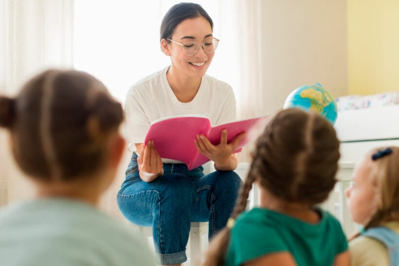 A teacher reading a book