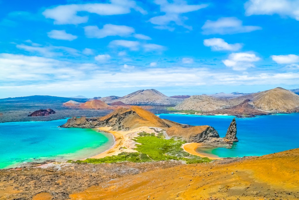 Bartolome Island is a volcanic islet in the Galapagos Islands with an amazing viewpoint at the top. It is a must see destination when visiting Ecuador.