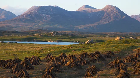 Peter Zoeller/Getty Images Many locals still hand-cut peat in the shadow of the Twelve Bens mountains (Credit: Peter Zoeller/Getty Images)