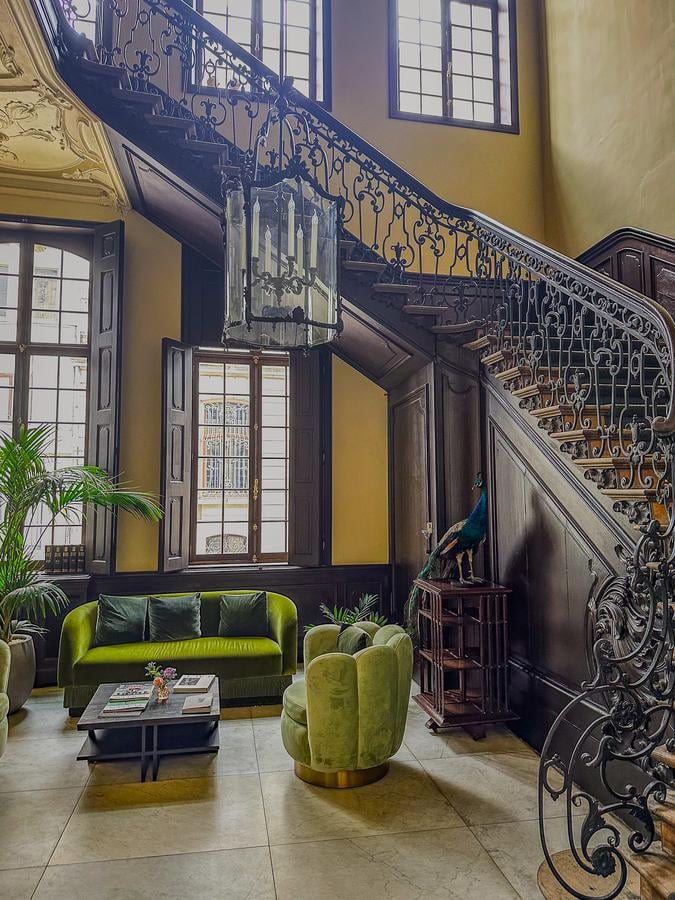 Elegant interior of Sapphire House Antwerp with ornate staircase and plush seating