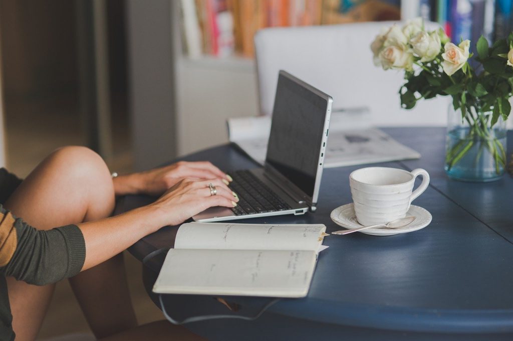 Photo of someone on a computer maybe managing their online bank account for someone who lives in another country.