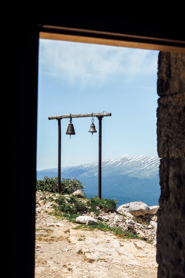 Two church bells hanging on a wooden frame outside the St George Church on Khvamli.